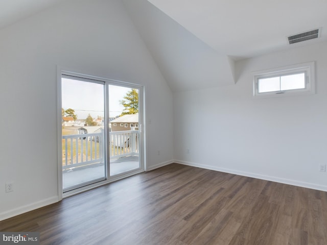 additional living space featuring lofted ceiling and dark hardwood / wood-style floors