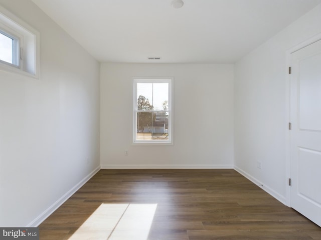 spare room with dark hardwood / wood-style flooring