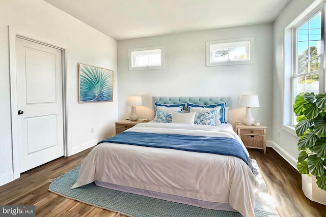 bedroom with dark hardwood / wood-style floors