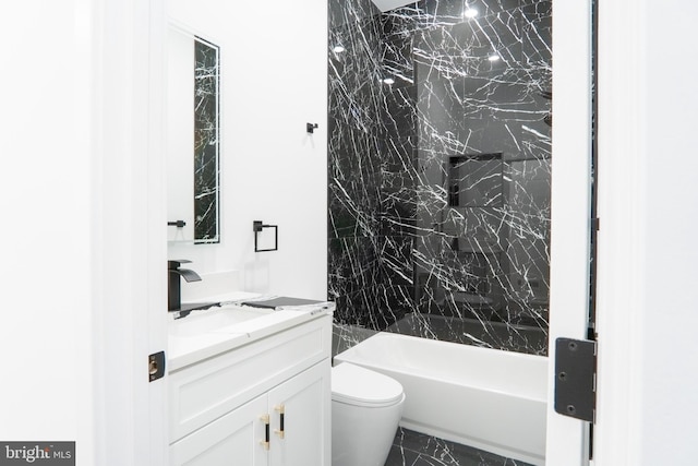 full bathroom with vanity, toilet, and tiled shower / bath