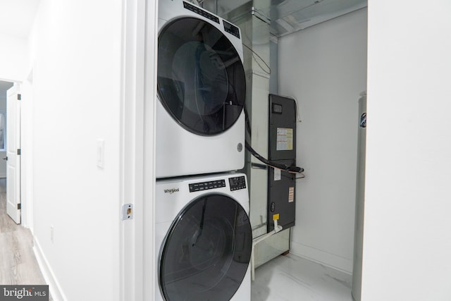 washroom featuring stacked washer and clothes dryer