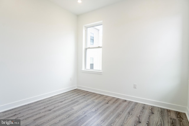 unfurnished room with light wood-type flooring