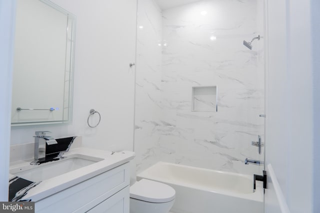 full bathroom with vanity, tiled shower / bath, and toilet