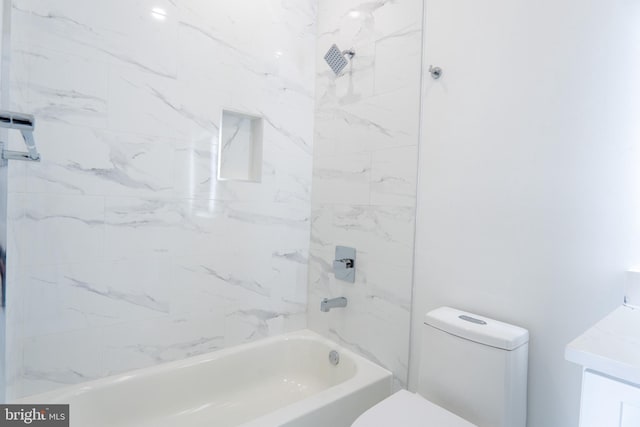 bathroom featuring toilet and tiled shower / bath combo