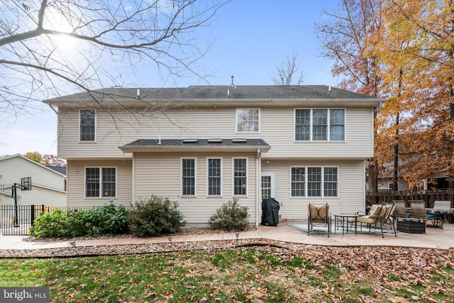 back of house with outdoor lounge area and a patio