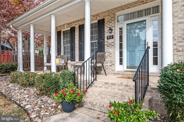 view of exterior entry with a porch