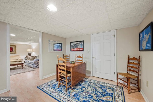 dining room featuring hardwood / wood-style floors and a paneled ceiling