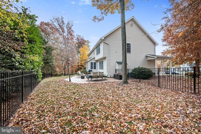 rear view of property featuring a patio area