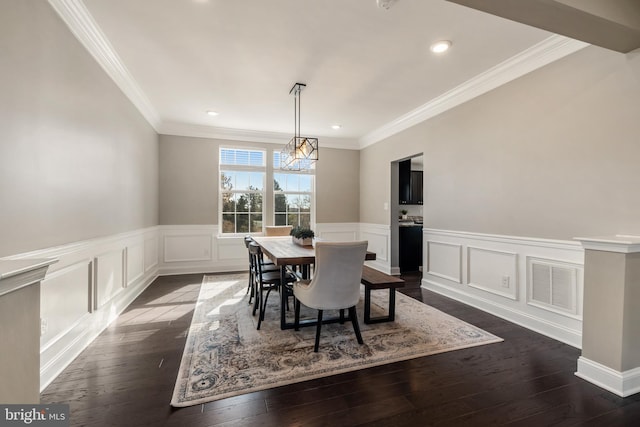 dining space featuring dark hardwood / wood-style floors and crown molding