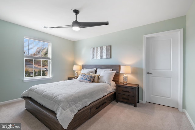 bedroom with ceiling fan and light carpet