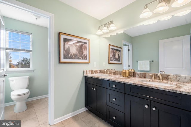 bathroom featuring vanity, tile patterned flooring, and toilet