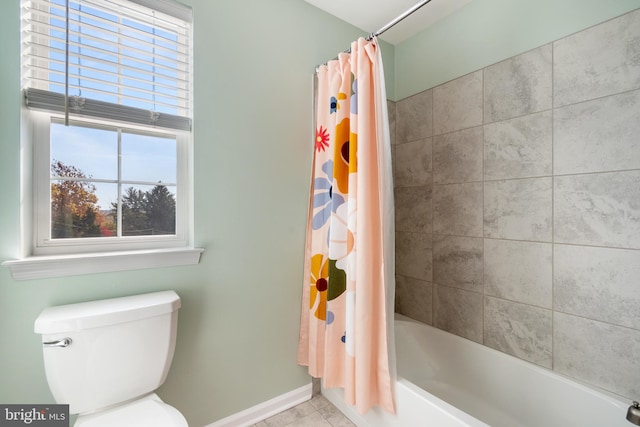 bathroom with shower / tub combo with curtain, toilet, and tile patterned floors