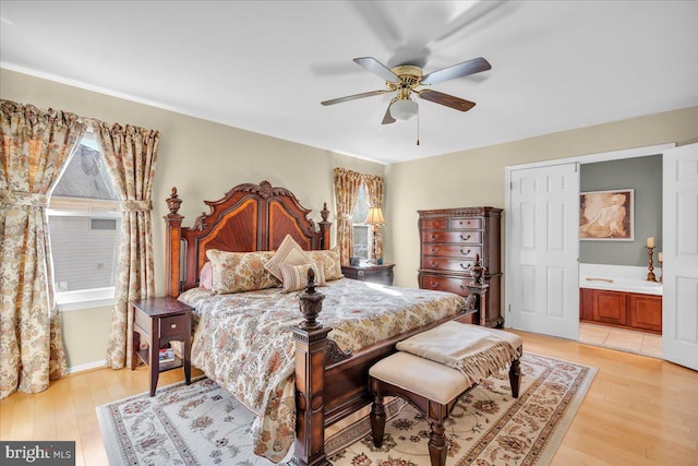 bedroom featuring ensuite bathroom, ceiling fan, and light hardwood / wood-style flooring