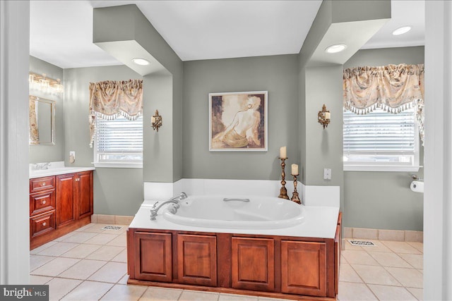 bathroom featuring vanity, a tub, and tile patterned flooring