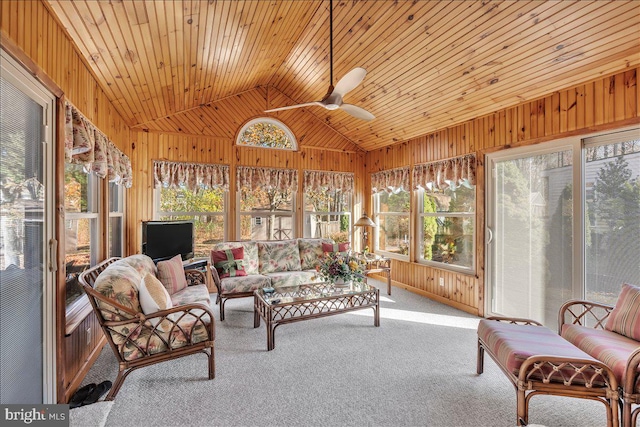 sunroom / solarium featuring vaulted ceiling, wooden ceiling, and ceiling fan