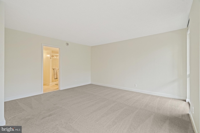 unfurnished room featuring light colored carpet