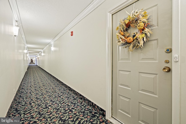 corridor with a textured ceiling and ornamental molding