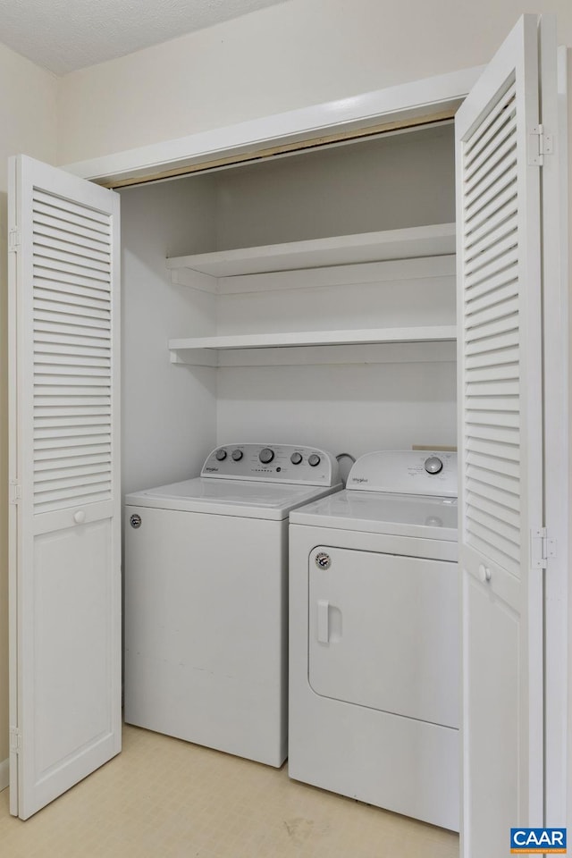 clothes washing area with washer and dryer