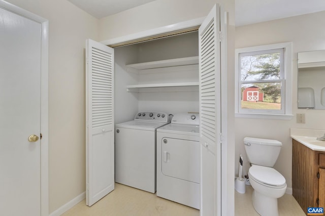 washroom with washing machine and clothes dryer