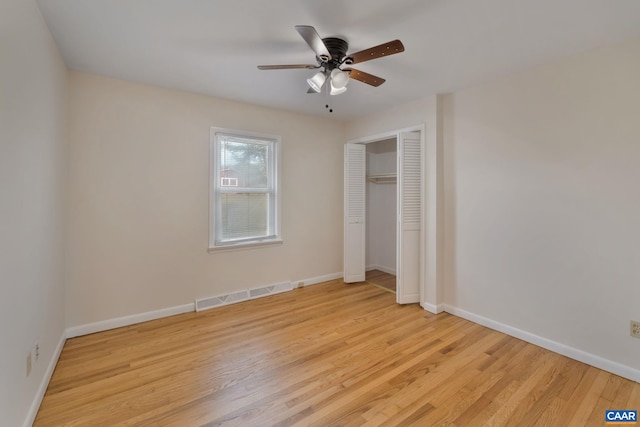 unfurnished bedroom with ceiling fan, a closet, and light wood-type flooring