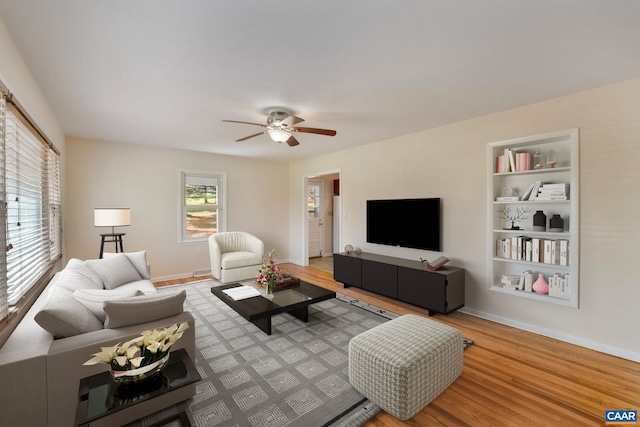 living room with hardwood / wood-style flooring and ceiling fan