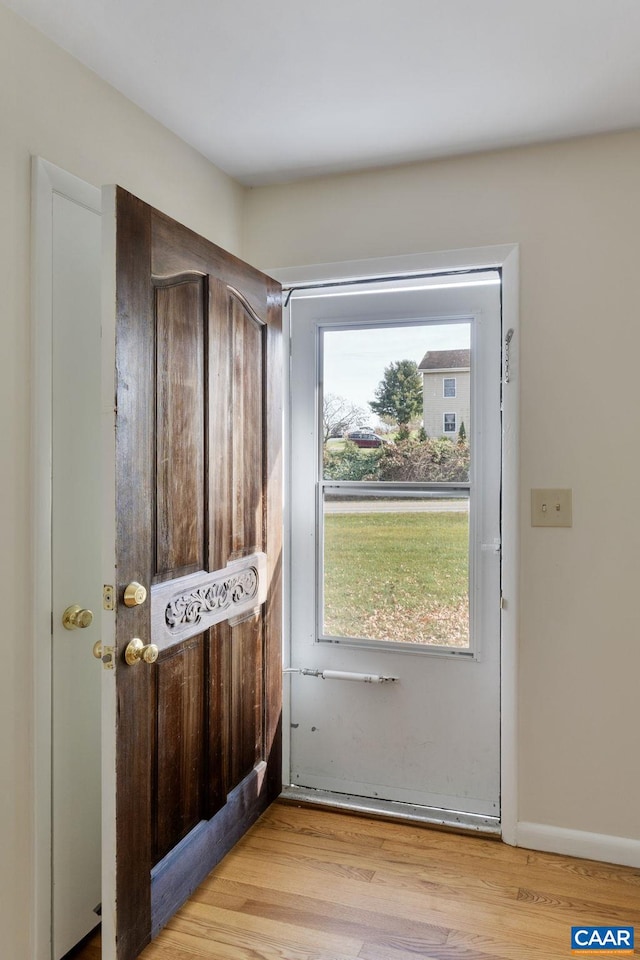 doorway with light wood-type flooring