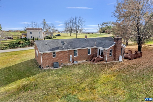 back of property featuring central air condition unit, a wooden deck, and a lawn