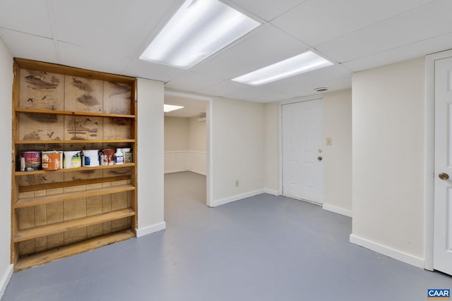 basement featuring a paneled ceiling