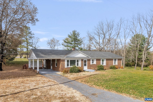 ranch-style house featuring a front yard and a carport