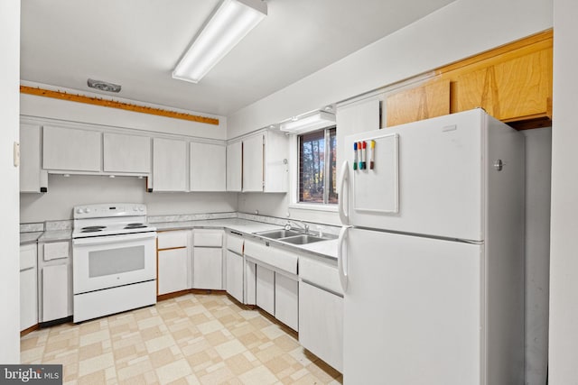 kitchen with white appliances, sink, and white cabinets