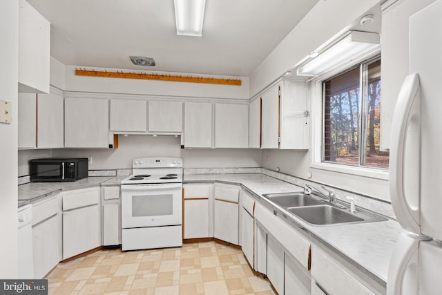 kitchen with white cabinetry, white appliances, and sink