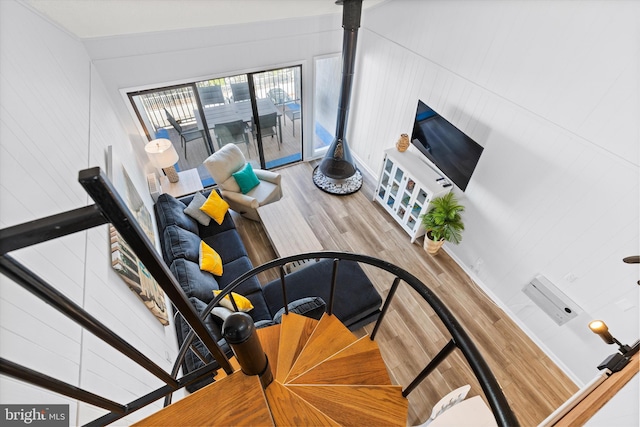 living room featuring vaulted ceiling and light hardwood / wood-style flooring