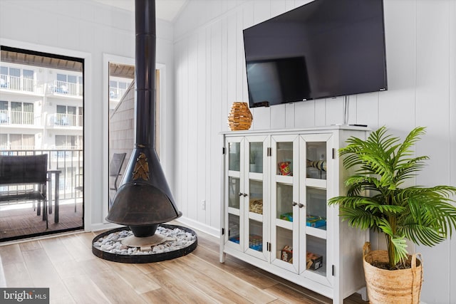 room details featuring hardwood / wood-style floors and a wood stove