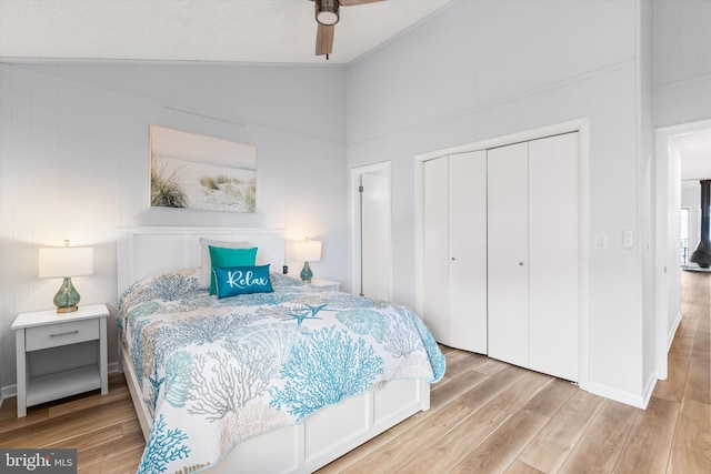 bedroom with a closet, vaulted ceiling, ceiling fan, and wood-type flooring