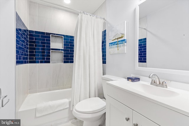 full bathroom featuring vanity, shower / bath combination with curtain, and toilet