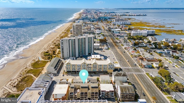 drone / aerial view featuring a water view and a beach view