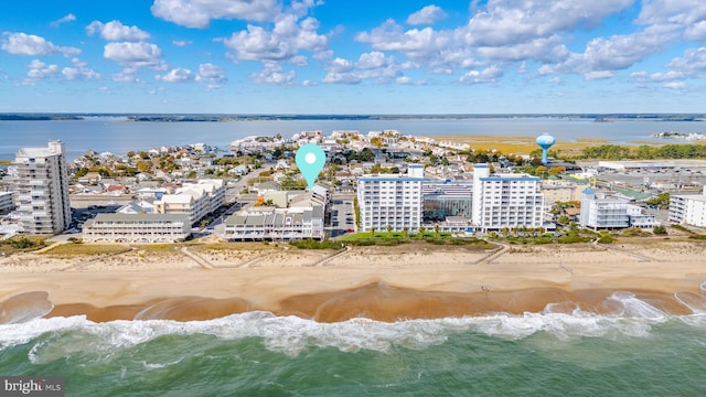 aerial view with a water view and a beach view