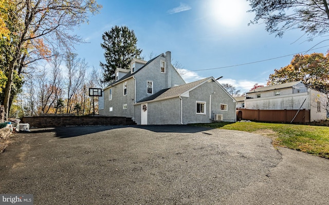 back of property featuring central air condition unit