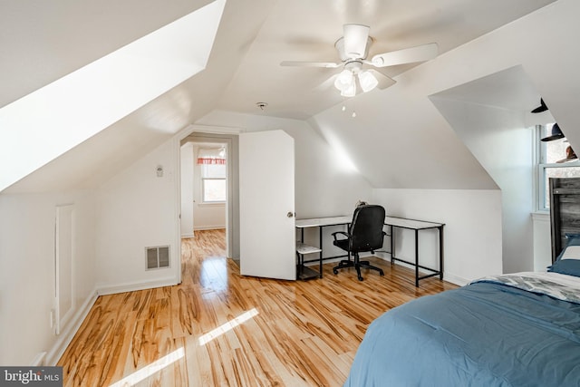 bedroom with ceiling fan, light hardwood / wood-style flooring, and lofted ceiling