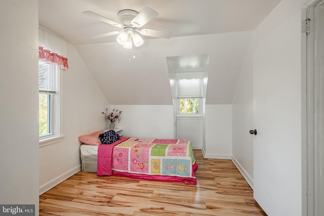 bedroom featuring light wood-type flooring, ceiling fan, and vaulted ceiling