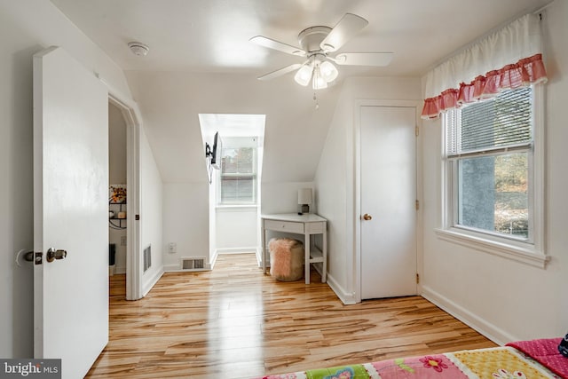 additional living space with light hardwood / wood-style flooring, lofted ceiling, and ceiling fan