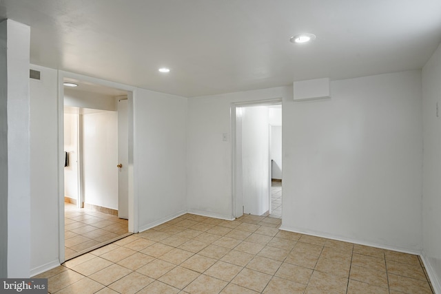 unfurnished room featuring light tile patterned floors