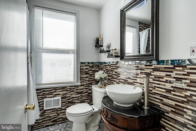 bathroom featuring tile walls, vanity, and plenty of natural light