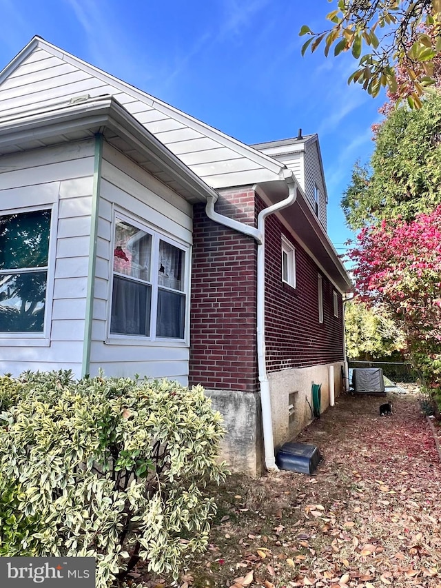 view of side of home featuring cooling unit