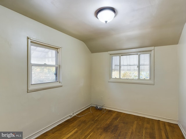 bonus room featuring vaulted ceiling and dark hardwood / wood-style floors