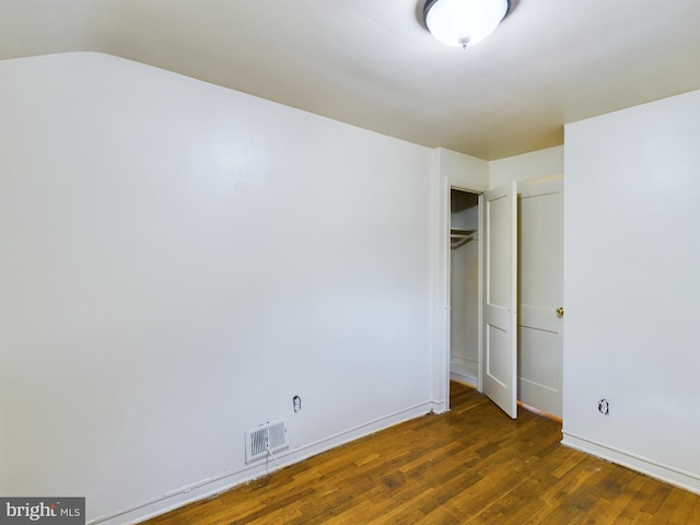 spare room with wood finished floors and baseboards