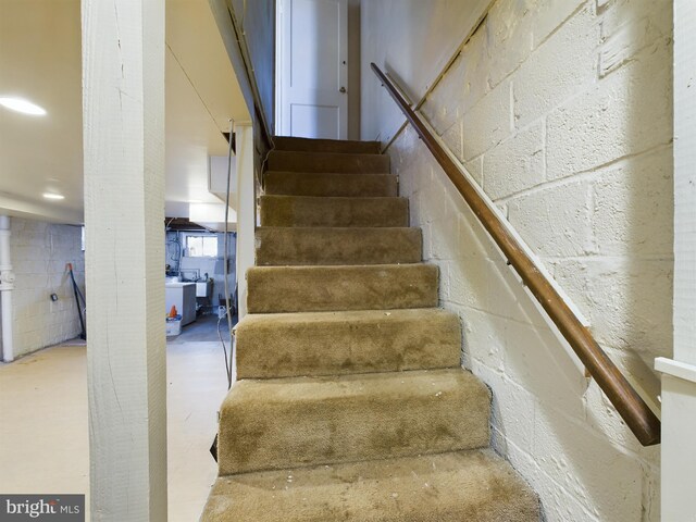 stairs with concrete block wall