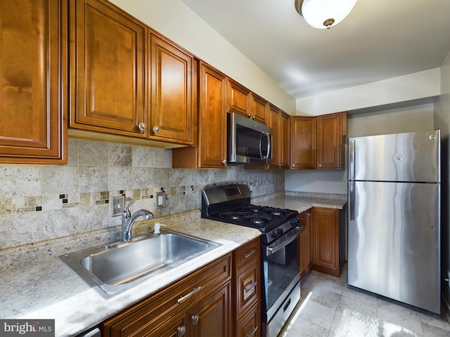 kitchen featuring sink, appliances with stainless steel finishes, and tasteful backsplash