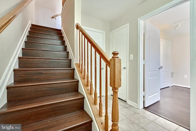 stairs featuring hardwood / wood-style floors