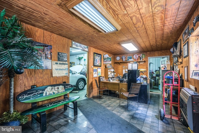 interior space with wooden walls, wooden ceiling, and heating unit